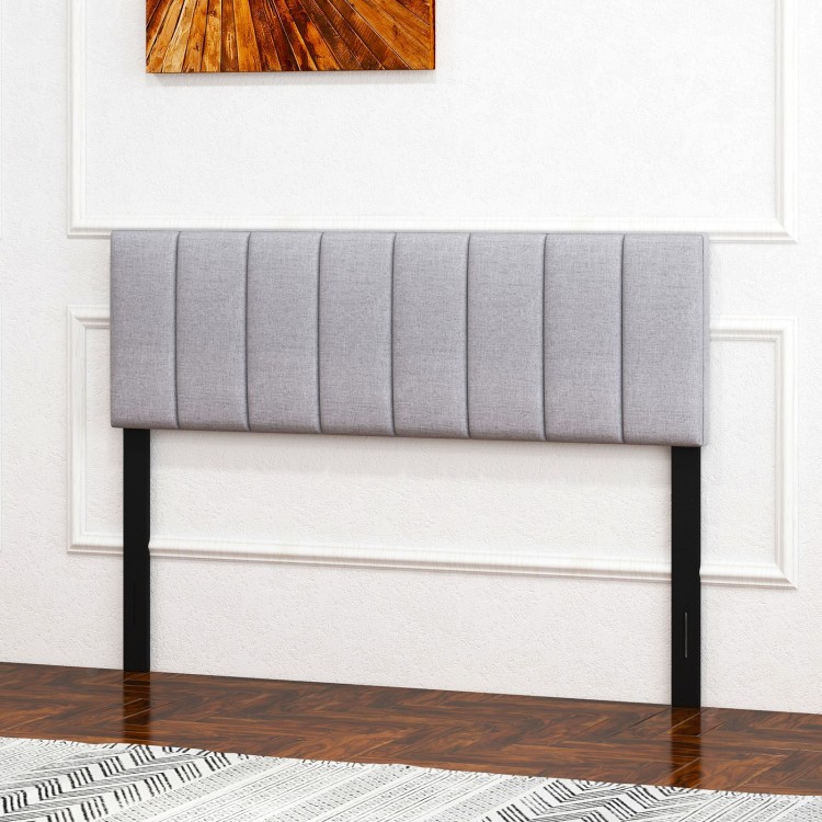Gray linen upholstered headboard with vertical channel tufting, adjustable width, and solid wood legs for full or queen.