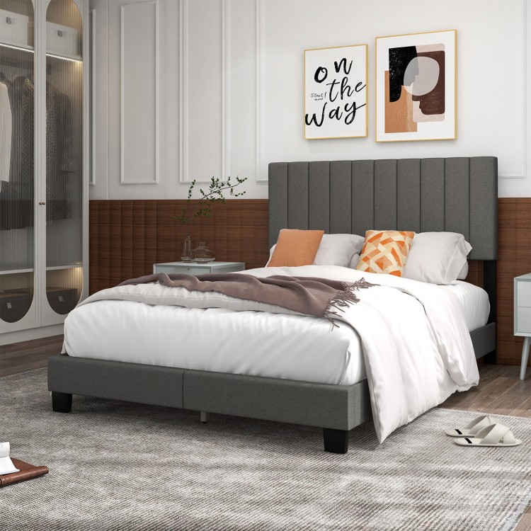 Gray queen size upholstered bed frame featuring a vertical channel tufted headboard and cozy bedding, ideal for stylish.