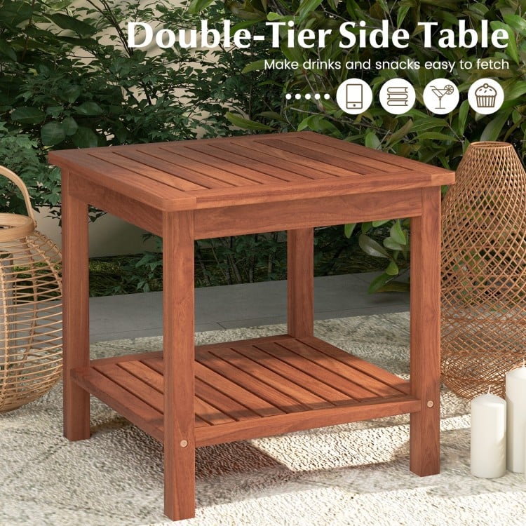 Double-tier acacia wood patio side table with slatted top and shelf, ideal for drinks and snacks in outdoor settings.