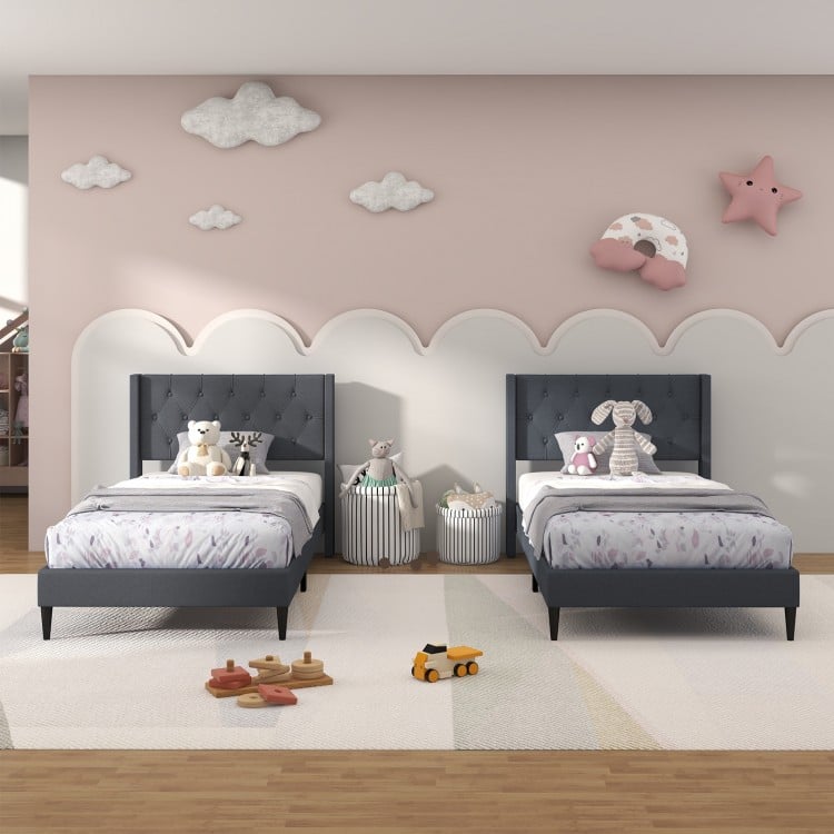 Twin size upholstered platform beds with button tufted gray headboards, ideal for stylish bedroom or guest room decor.