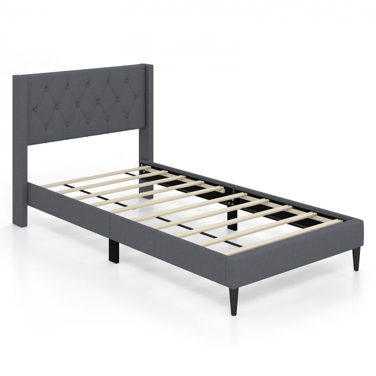 Twin size upholstered platform bed in gray with button tufted wingback headboard and sturdy wooden slats for support.