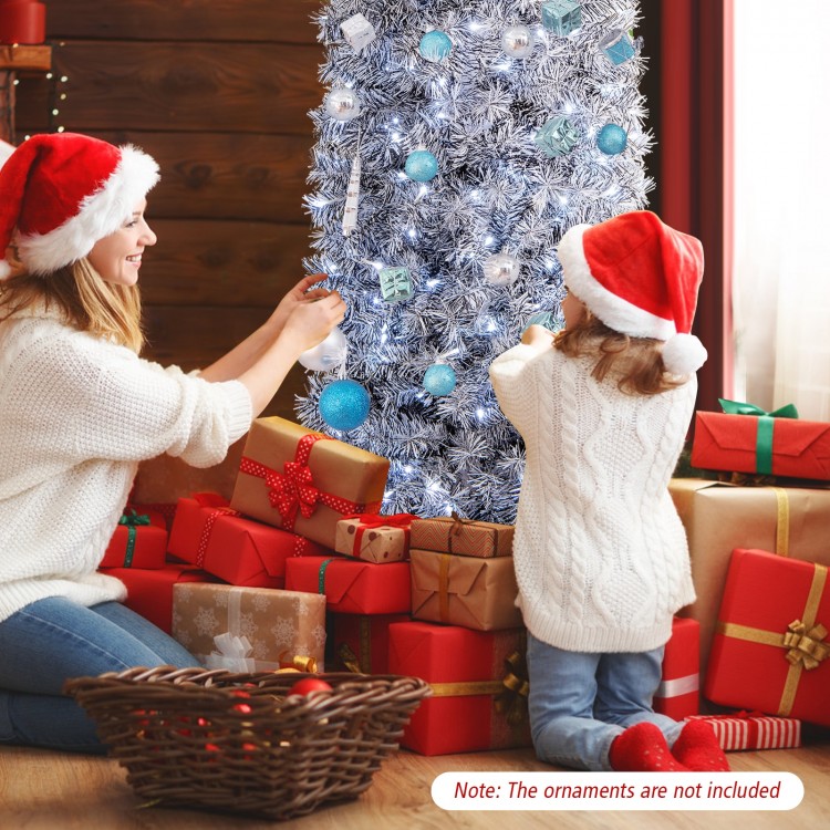 A family decorates a 6 ft pre-lit artificial Christmas tree with black and white leaves, surrounded by festive gifts.