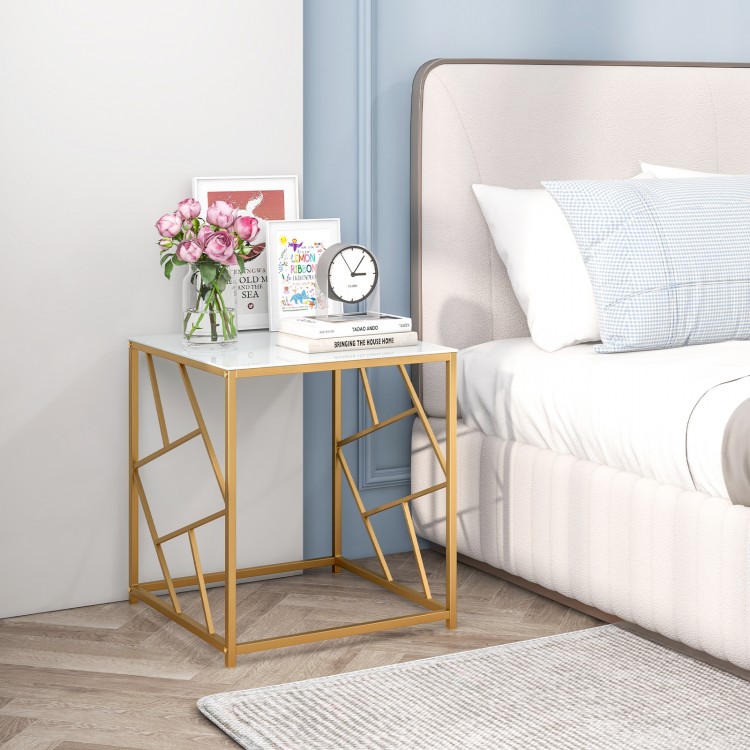 Square end table with a gold geometric frame and tempered glass top, perfect for stylish bedroom decor.