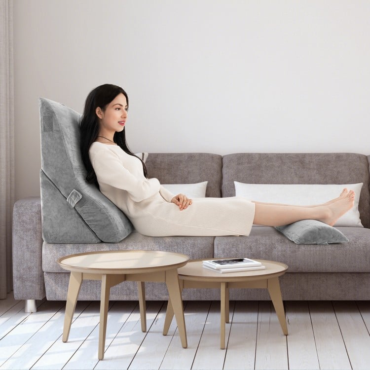 Adjustable orthopedic wedge pillow set in gray, providing ergonomic support for back, neck, and legs on a sofa.