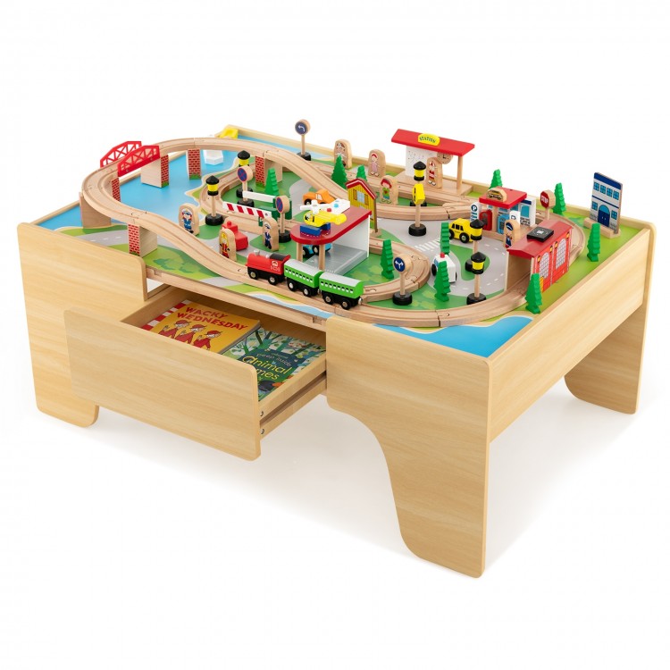 Wooden train set with 84 pieces on a reversible tabletop, featuring a gas station and storage drawer for kids' play.