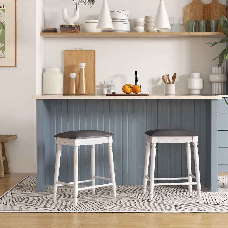 Two 24-inch bar stools with padded seats and wood legs, perfect for kitchen or dining room use.