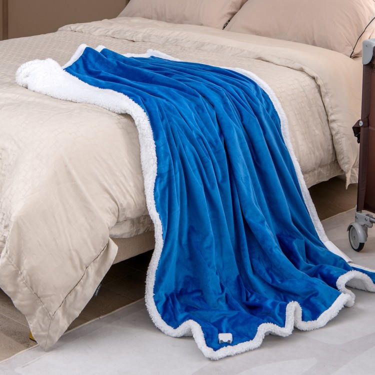 Soft blue heated electric blanket throw with sherpa fleece, featuring 10 heat levels, draped over a bed for cozy warmth.
