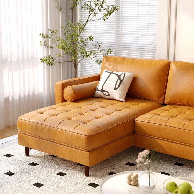 L-shaped brown sectional sofa with tufted air leather, plush cushions, and bolster pillows for living room comfort.
