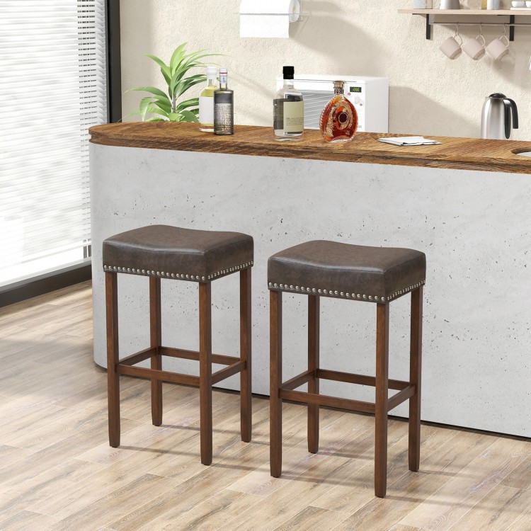 Set of 2 gray upholstered bar stools with footrests, featuring natural rubber wood legs for durability and comfort.
