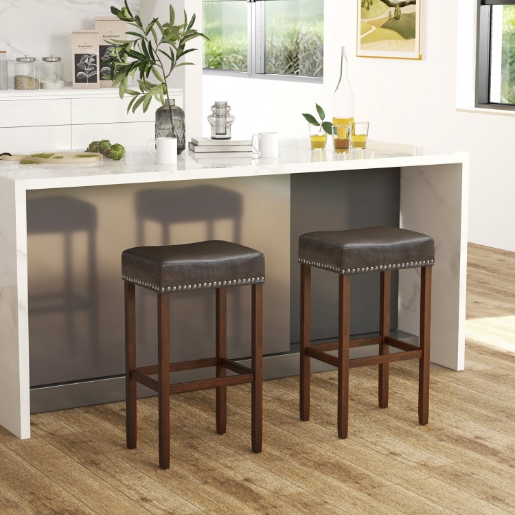 Saddle-shaped gray upholstered bar stools set of 2 with rubber wood legs and footrests for kitchen islands or dining.