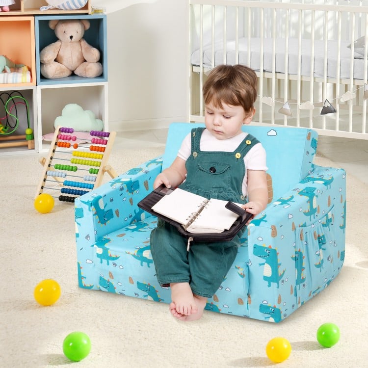 Kids recliner sofa in blue with dinosaur pattern, convertible to sleeper bed, featuring armrests and storage pockets.