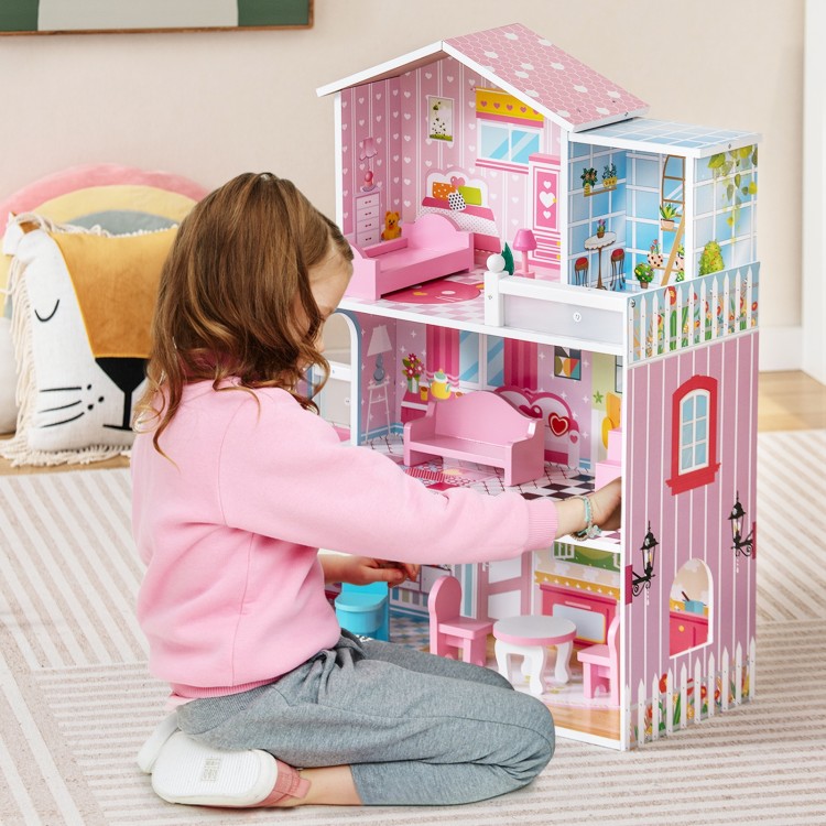 Kids playing with a pink wooden dollhouse featuring 5 rooms and movable furniture for imaginative play.