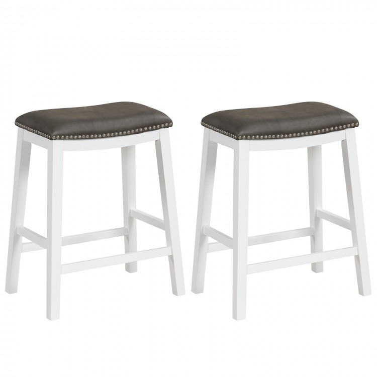 Set of 2 gray upholstered 26-inch counter height bar stools with saddle seats and rivet accents for comfortable seating.