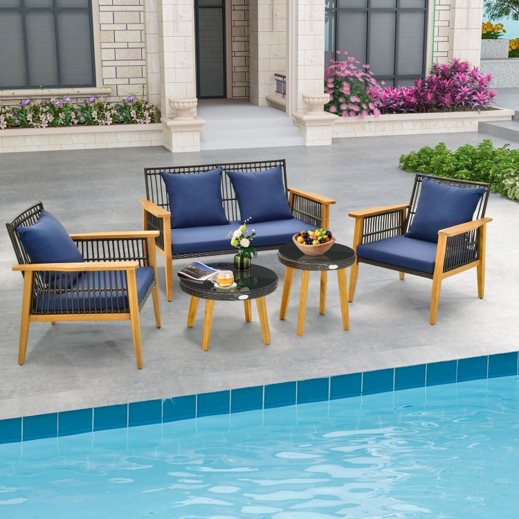 5-piece outdoor conversation set featuring navy cushions, acacia wood frame, and two coffee tables for poolside.
