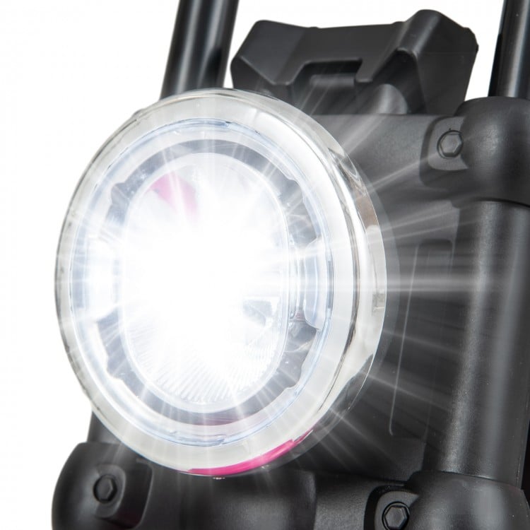 Close-up of the bright LED headlight on a pink kids electric motorcycle, featuring training wheels for safe riding.