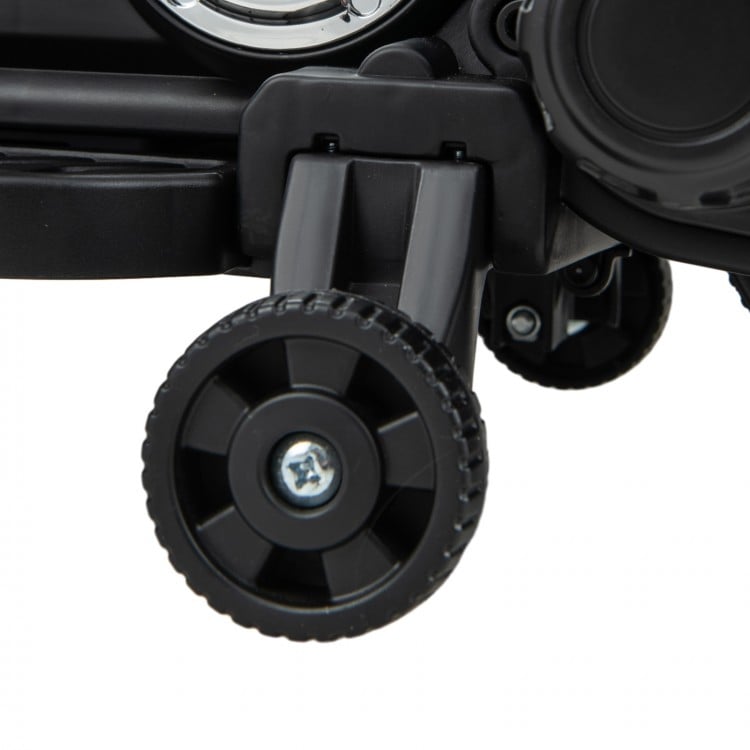 Close-up of the training wheels on a pink kids electric motorcycle, featuring durable design for stability and safety.