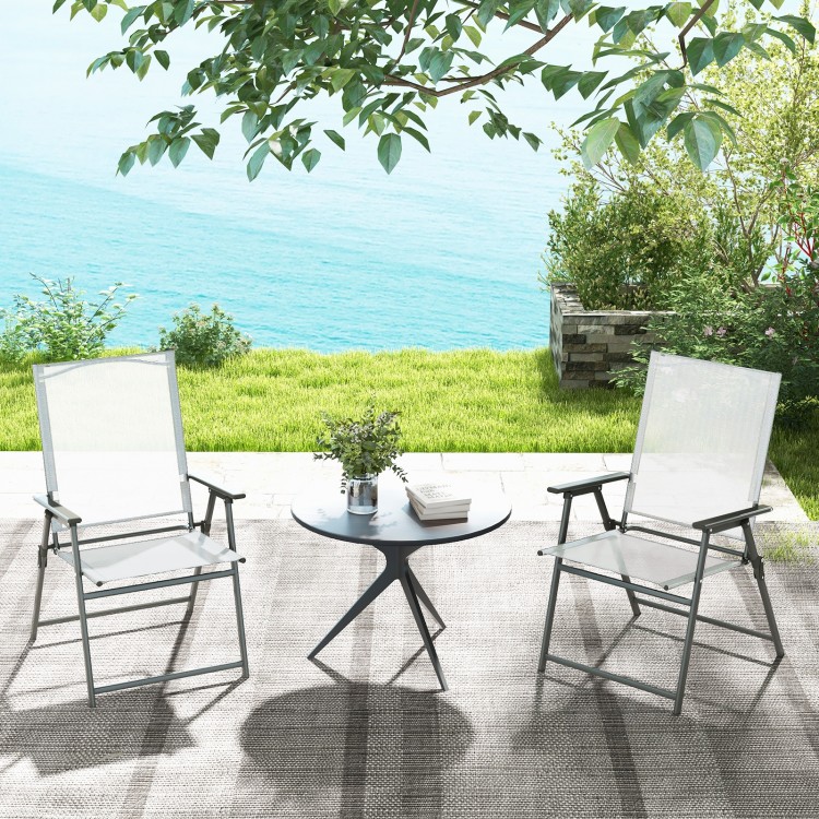 Set of 4 white patio folding chairs with rustproof metal frame, ideal for backyard relaxation and easy storage.