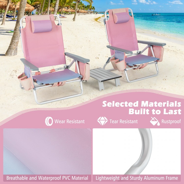 Two pink reclining beach chairs with a side table, featuring a durable aluminum frame and adjustable positions for.
