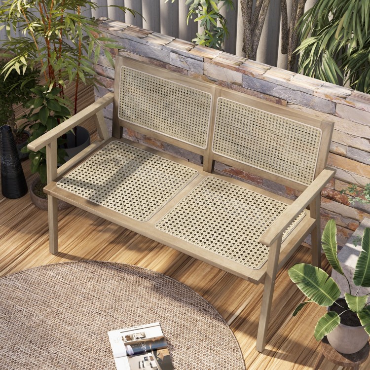 Teak wood garden bench with natural rattan backrest, designed for two, perfect for patio or garden relaxation.