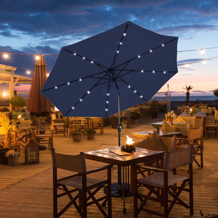 Dark blue 9-foot solar LED lighted patio umbrella with crank lift and tilt adjustment, perfect for outdoor dining.