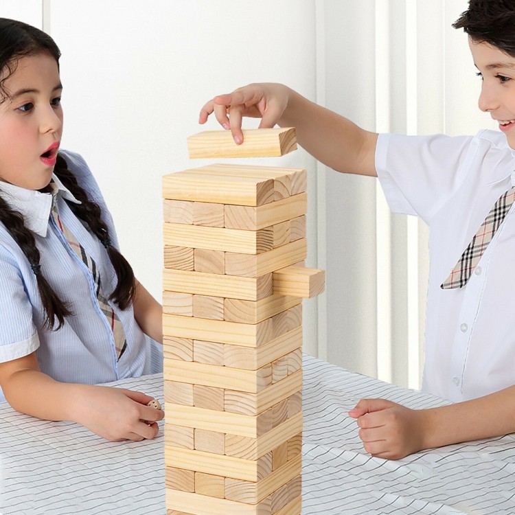 Children playing with a 54-piece tumbling timber toy made of natural pine wood, promoting coordination and imagination.