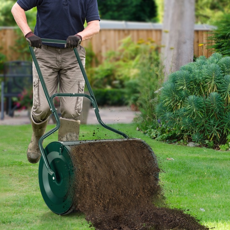 24-inch peat moss spreader with U-shape handle, showcasing even spreading of compost in a garden setting.