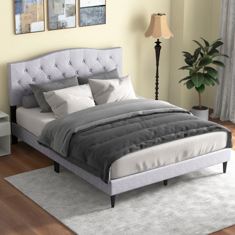 Queen size upholstered platform bed showcasing a stylish button tufted headboard and cozy bedding for enhanced comfort.