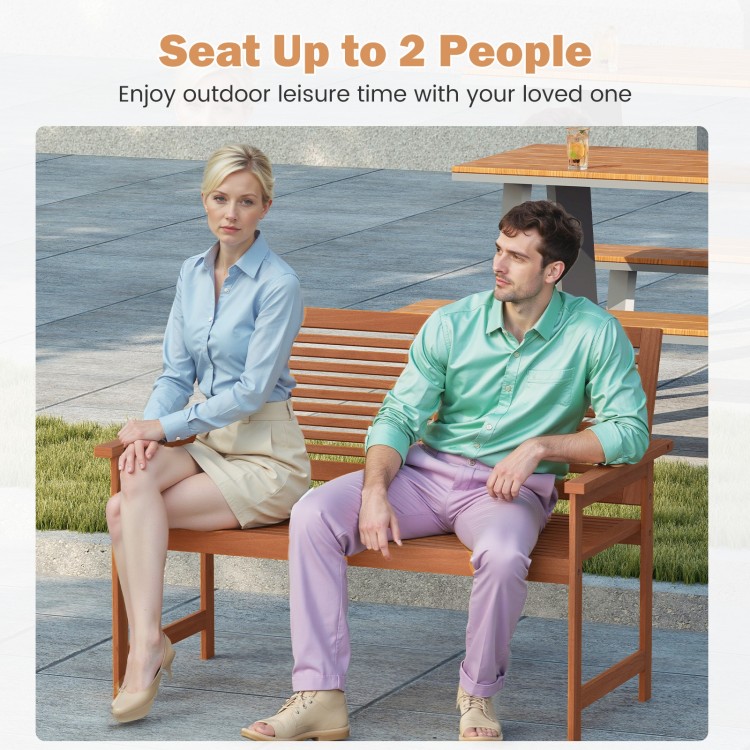 Outdoor wooden bench seating up to 2 people, featuring a slatted backrest and wide armrests for patio relaxation.