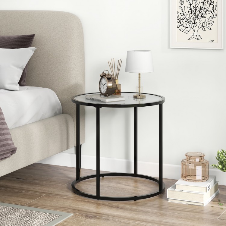 Round glass end table with a black metal frame and faux marble top, perfect for living room or bedroom use.