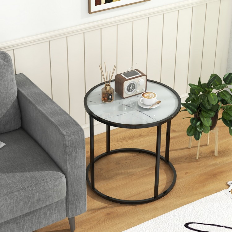 Round glass end table with faux marble top and black metal frame, perfect for living room or bedroom decor.