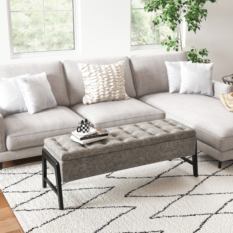 Modern gray chenille storage bench with tufted design and rubber wood legs, perfect for living room organization.