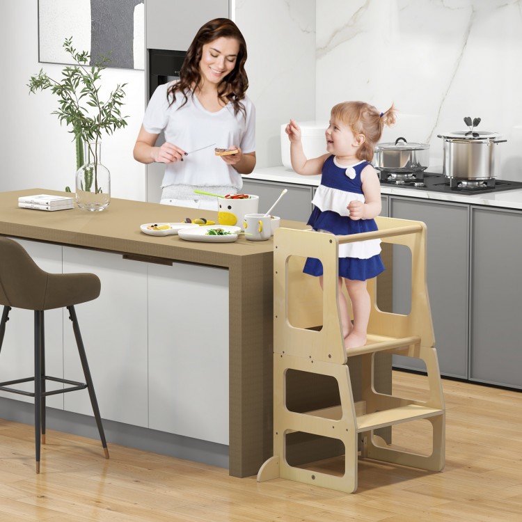 Toddler using the 3-in-1 foldable kitchen standing tower with chalkboard, promoting independence in family activities.