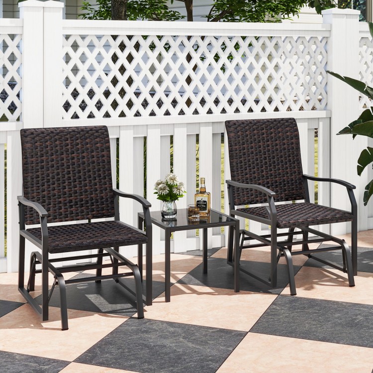 Two brown patio gliding chairs with a tempered glass coffee table, perfect for backyard relaxation.