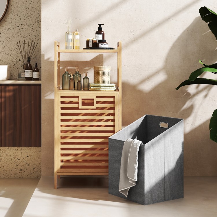 Bamboo tilt-out laundry hamper with foldable basket and two-tier shelves, ideal for bathrooms and laundry rooms.