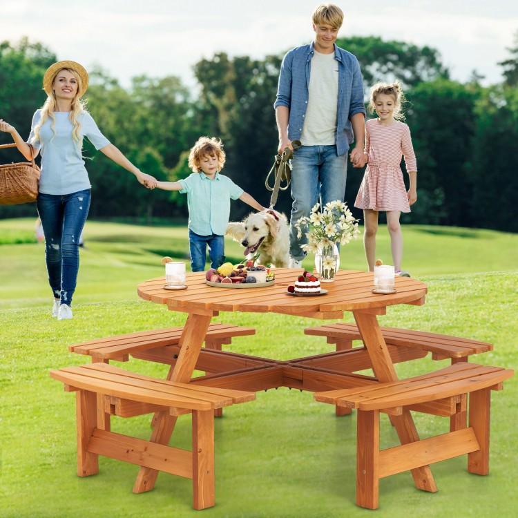 Round picnic table set in natural fir wood with slatted tops, perfect for outdoor meals with family and friends.