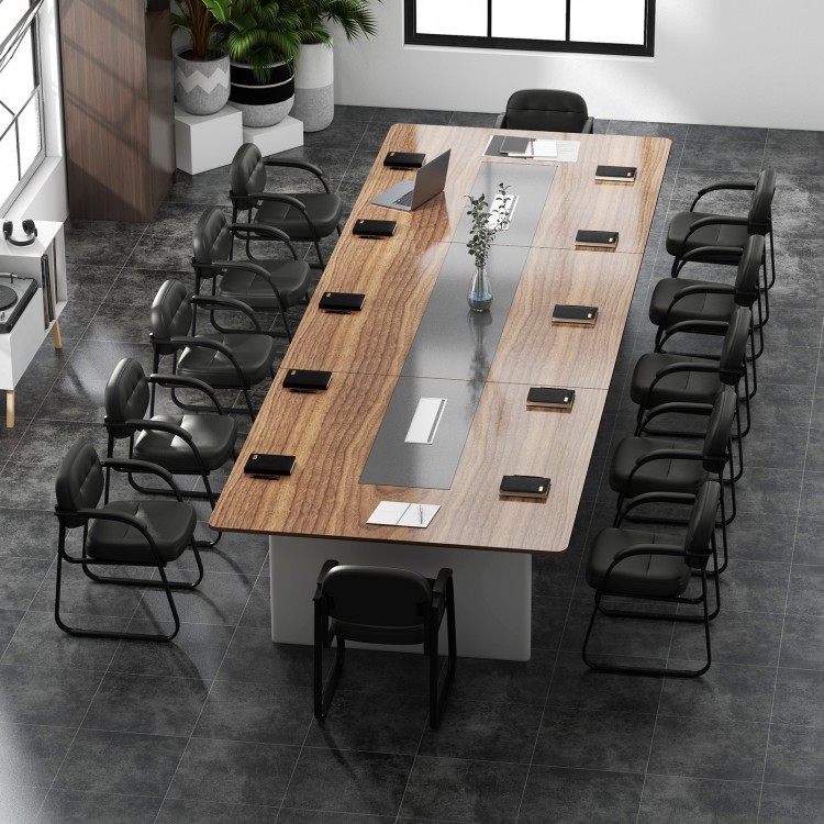 Black reception chairs with sled base and padded armrests, ideal for office or waiting room use, shown in a conference.