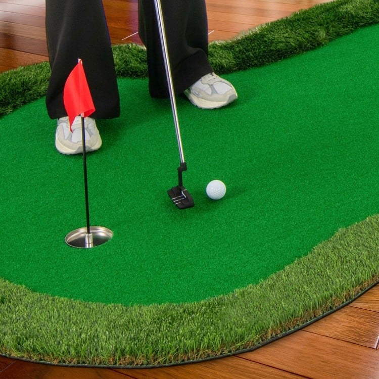 Golf practice putting green mat with realistic turf, featuring three holes and a golf ball for indoor or outdoor use.