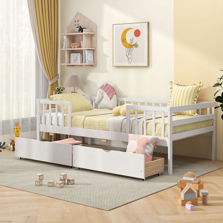 Twin daybed with fence in white, featuring two spacious drawers, perfect for kids' rooms and promoting independence.