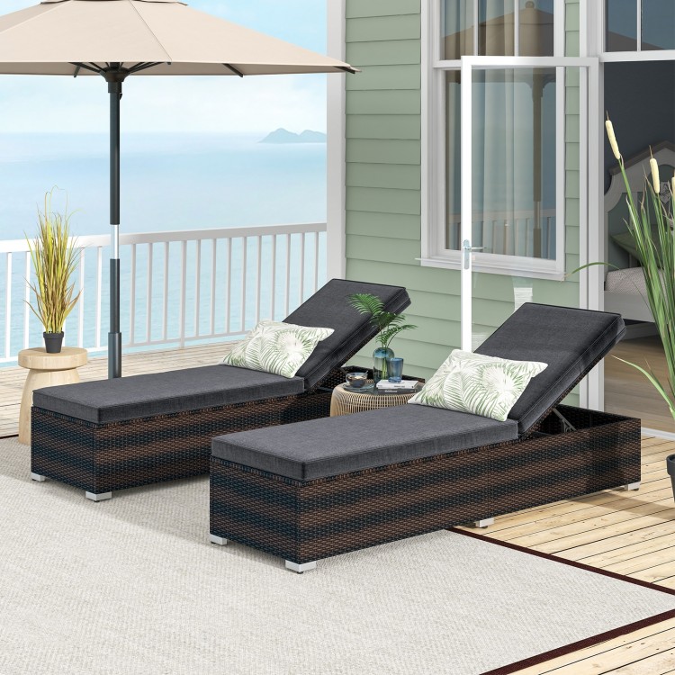 Patio wicker lounge chairs with adjustable backrests and gray cushions, perfect for outdoor relaxation by the pool.