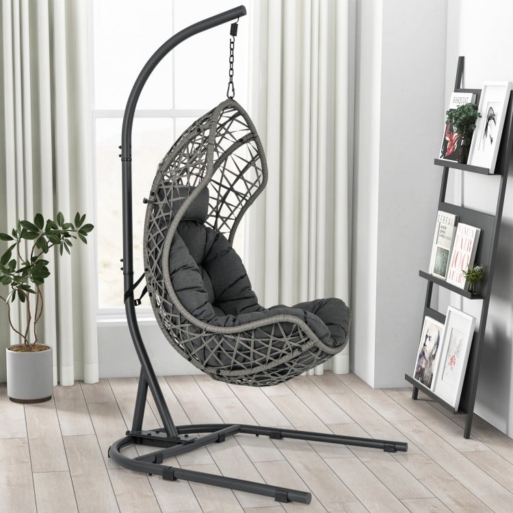 Gray egg chair with stand, featuring PE rattan, cushion, and pillow, ideal for indoor or outdoor relaxation.
