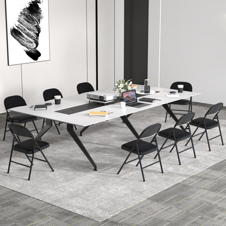 Black folding chairs with metal frame and PVC leather, arranged around a conference table for meetings and events.