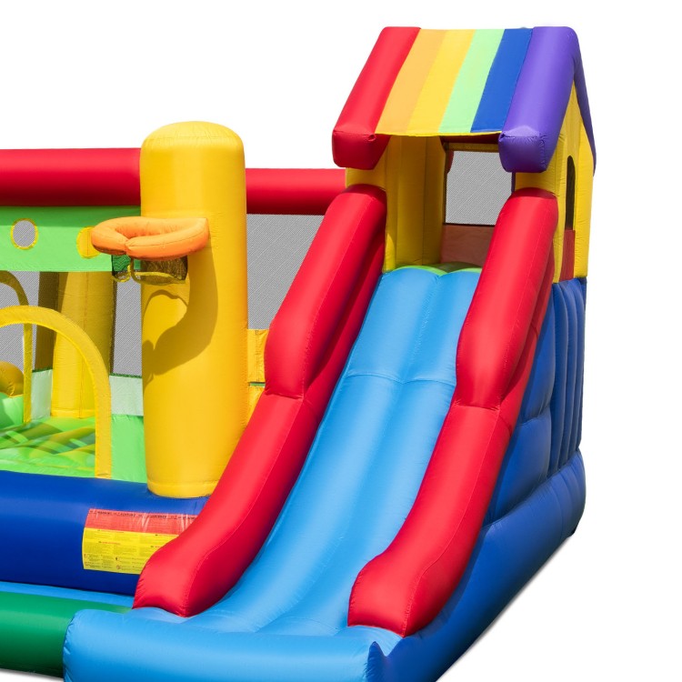 Colorful inflatable bounce castle with double slides, climbing wall, and basketball hoop for outdoor fun.