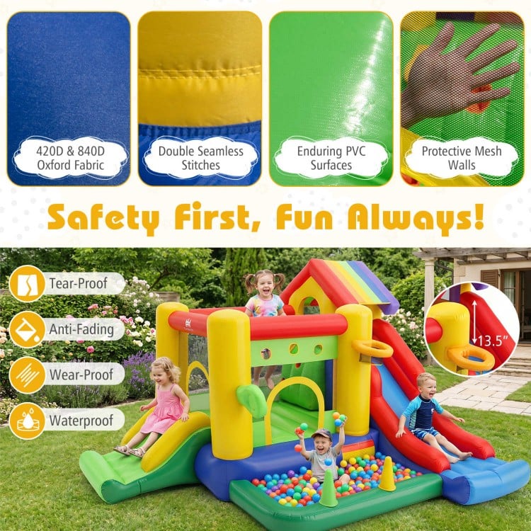 Rainbow inflatable bounce castle featuring double slides, climbing wall, and ocean ball pool for outdoor fun.