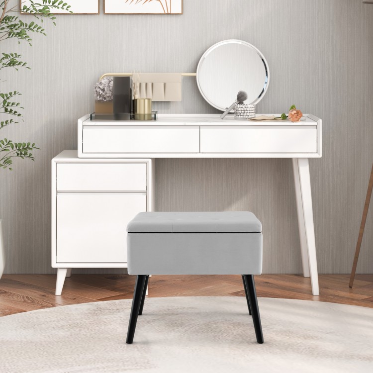 Gray velvet storage ottoman with solid wood legs, featuring a hinged lid for convenient storage and a chic design.