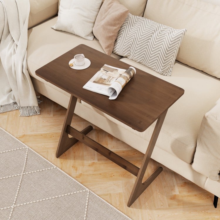 Z-shaped brown bamboo side table with spacious tabletop, ideal for snacks and laptops, perfect for small living spaces.