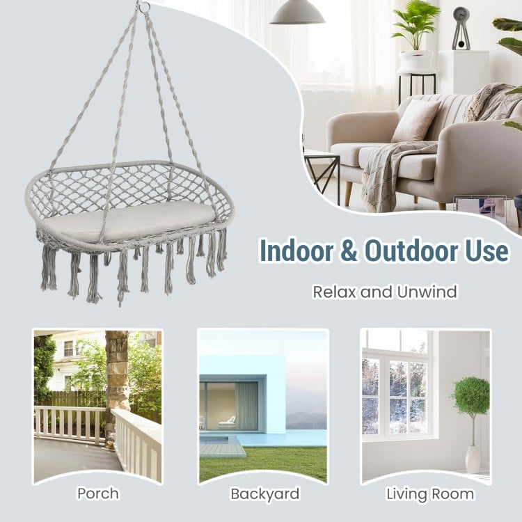 Gray 2-person macrame hammock chair with cushion, perfect for indoor and outdoor relaxation in any space.