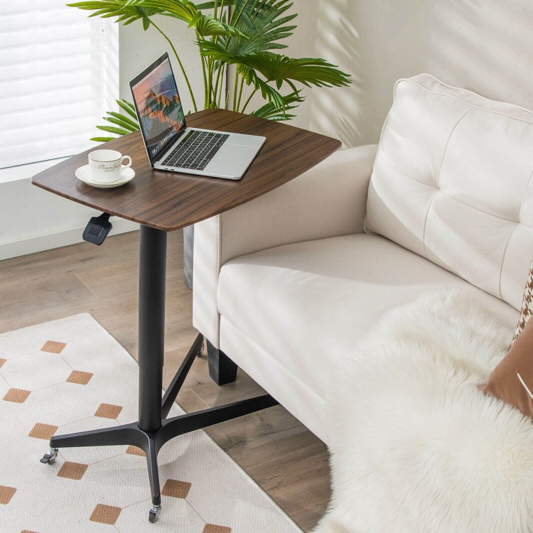 Height adjustable mobile standing desk in brown with lockable wheels, perfect for working or eating in living rooms.