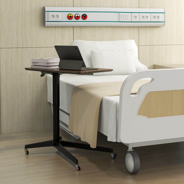 Height adjustable mobile standing desk in brown with lockable wheels, ideal for hospital or home use for working and.