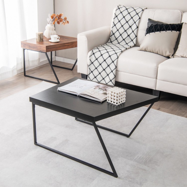 Black coffee table from a set of 2 with powder-coated metal legs, featuring a spacious tabletop and unique trapezoid.