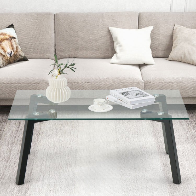 Modern tempered glass coffee table with metal frame, featuring a spacious top and stylish design for living room use.